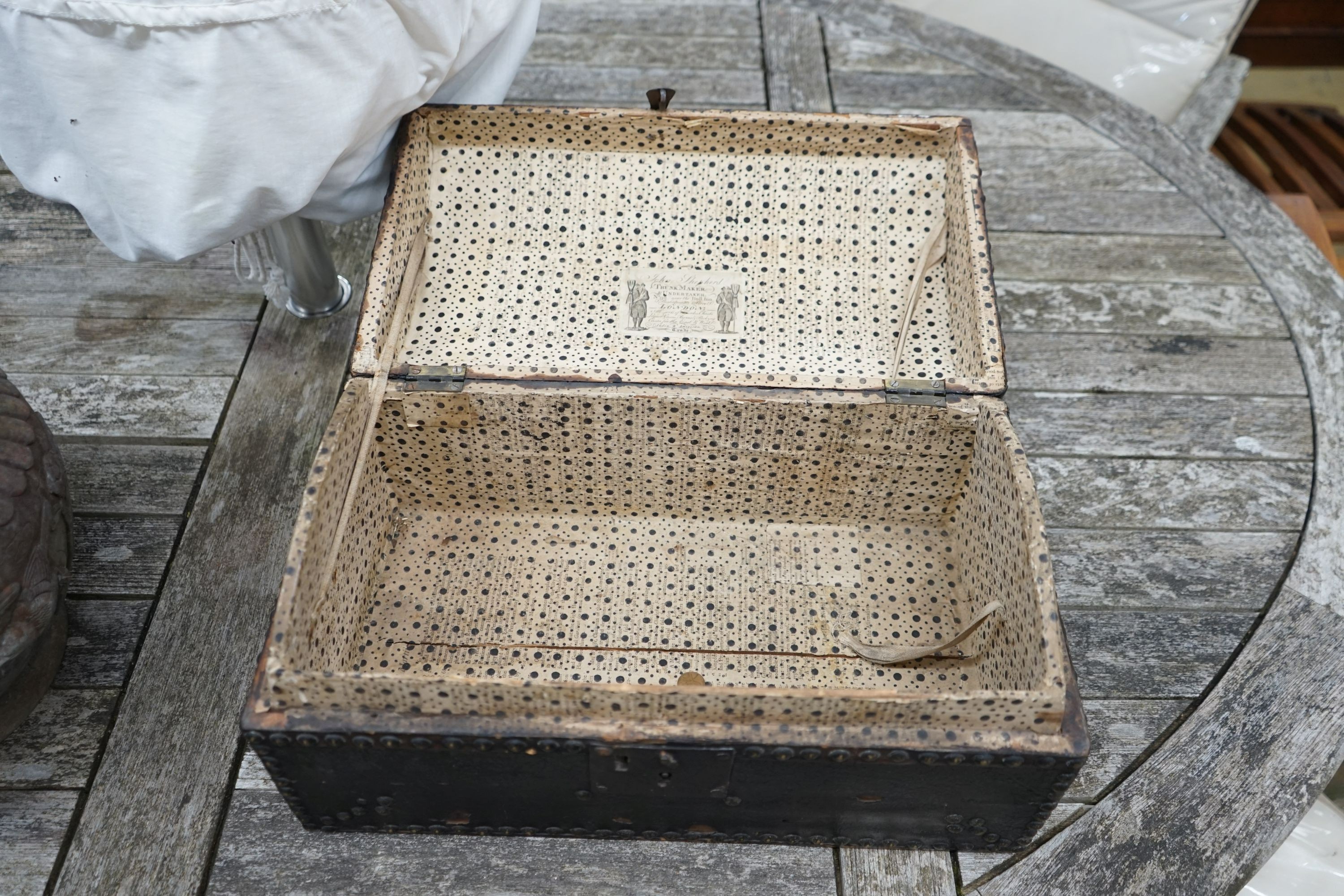 An early 19th century small domed topped leather trunk, bears interior label John Shepherd, Trunk Maker and Undertaker, London, width 45cm, depth 26cm, height 23cm